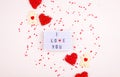 A gentle background with hearts, a gift, a light box and words. Valentine`s Day