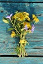 A gentle bouquet of wildflowers. Small flowers on a green wooden background Royalty Free Stock Photo