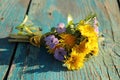 A gentle bouquet of wildflowers. Small flowers on a green wooden background Royalty Free Stock Photo