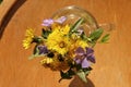 A gentle bouquet of wildflowers. Small flowers on a wooden background Royalty Free Stock Photo