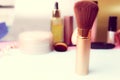 Gentle brush of natural lint for applying powder on the background of a cosmetic table for makeup for beauty guidance