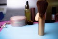 Gentle brush of natural lint for applying powder on the background of a cosmetic table for makeup for beauty guidance