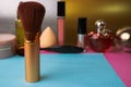 Gentle brush of natural lint for applying powder on the background of a cosmetic table for makeup for beauty guidance