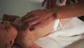 Gentle corpsman hands rub baby stomach during massage