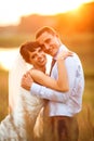 Gentle couple is posing on the background beautiful sunset Royalty Free Stock Photo