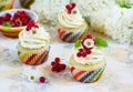 Gentle cupcake with cream and berries on a light background