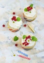 Gentle cupcake with cream and berries nd a candle a light background