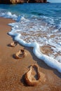 Gentle footprints in the sand leading towards the ocean