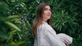 Gentle girl walking botanic garden closeup. Brunette lady looking camera alley Royalty Free Stock Photo