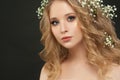 Gentle girl with white flowers on black, beautiful face closeup Royalty Free Stock Photo