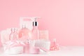 Gentle girlish dressing table with cosmetics products - rose oil, bath salt, cream, perfume, cotton towel, bottle, bowl, box.