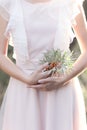 Gentle graceful hands of bride Girl with branch of sea buckthorn in the hand in a gentle air wedding dress in the sun rays at Royalty Free Stock Photo