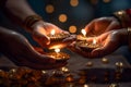 Gentle hands holding the Diwali diyas, symbolizing the triumph of light over darkness