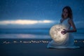 Gentle image of a girl, Astrology, Female magic. Beautiful attractive girl on a night beach with sand hugs the moon, art Royalty Free Stock Photo