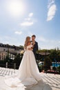 gentle and loving bride and groom in traditional wedding clothes on the terrace. Royalty Free Stock Photo