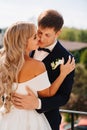 gentle and loving bride and groom in traditional wedding clothes on the terrace. Royalty Free Stock Photo