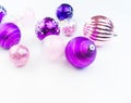 Gentle pink and purple baubles on a white background. Christmas mood. Copy space Royalty Free Stock Photo