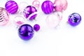 Gentle pink and purple baubles on a white background. Christmas mood. Copy space Royalty Free Stock Photo