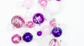 Gentle pink and purple baubles on a white background. Christmas mood. Copy space Royalty Free Stock Photo