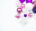 Gentle pink and purple baubles on a white background. Christmas mood. Copy space Royalty Free Stock Photo