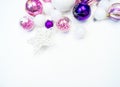 Gentle pink and purple baubles on a white background. Christmas mood. Copy space Royalty Free Stock Photo