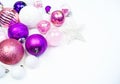 Gentle pink and purple baubles on a white background. Christmas mood. Copy space Royalty Free Stock Photo