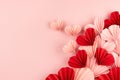 Gentle pink and red hearts of chinese paper fans flying on pastel pink color as elegant curved love stream, top view, copy space. Royalty Free Stock Photo