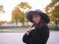 gentle portrait of a beautiful woman in a large hat and black coat Royalty Free Stock Photo