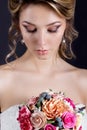 Gentle portrait of happy smiling beautiful girls in white wedding dress with a wedding bouquet in hand with beautiful hair Royalty Free Stock Photo