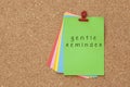 Gentle Reminder written on color sticker notes over cork board b Royalty Free Stock Photo