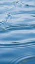 Gentle ripples spread across the surface of calm, clear water, creating soft waves. The light blue Royalty Free Stock Photo