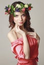 Gentle romantic appearance of the girl with a wreath of roses on her head and a pink dress. Joyful Jolly spring woman. Summer lady Royalty Free Stock Photo