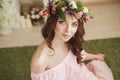 Gentle romantic appearance of the girl with a wreath of roses on her head and a pink dress. Joyful Jolly spring woman. Summer lady Royalty Free Stock Photo