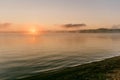 Gentle soft light pink dawn on the big lake, Sunrise, calm, fog, horizon line Royalty Free Stock Photo