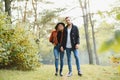 gentle and stylish couple are having a walk in the autumn park. Royalty Free Stock Photo