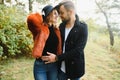 gentle and stylish couple are having a walk in the autumn park. Royalty Free Stock Photo