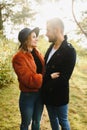 gentle and stylish couple are having a walk in the autumn park. Royalty Free Stock Photo