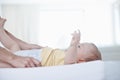 The gentle touch of a mother. A cute baby boy looking up at his mother as she changes his diaper. Royalty Free Stock Photo