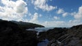 Gentle upward pan over coastal devonian rock rockpools