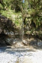 A gentle waterfall spills out from the lush rainforest on the West Coast Trail, Vancouver Island, BC