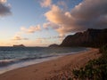 Gentle wave lap on Waimanalo Beach looking towards Rabbit island and Rock island at dawn Royalty Free Stock Photo