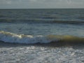 Gentle waves at dusk backlit by warm light Royalty Free Stock Photo