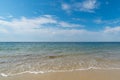 Gentle waves on an empty sandy beach with a calm ocean Royalty Free Stock Photo