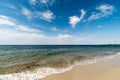 Gentle waves on an empty sandy beach with a calm ocean Royalty Free Stock Photo