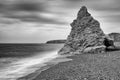 Gentle waves wash towards a sea stack. Seaham