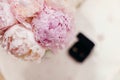 Gentle wedding bouquet peonies with rings background