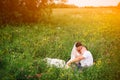 Gentle wedding couple lying on the meadow during sunset rises Royalty Free Stock Photo