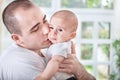 Gentle young father comforting crying baby Royalty Free Stock Photo