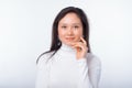 Gentle young woman portrait on white background while she touches her face. Royalty Free Stock Photo