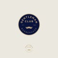 Gentleman club. Barbershop logo. Golden letters and mustaches in a dark blue circle. Male salon logo. Premium icon or sign.